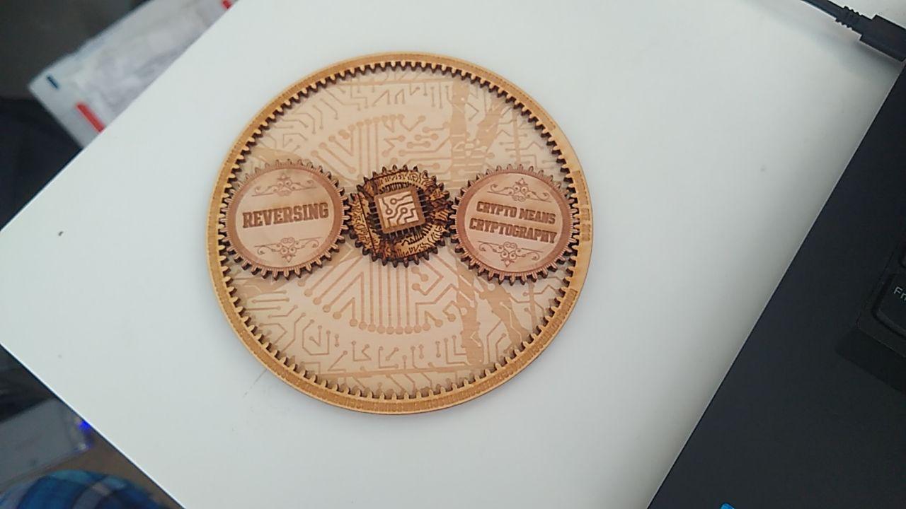 Photo of commemorative coin looking like a gear given to competitors at the 2019 Facebook Capture The Flag